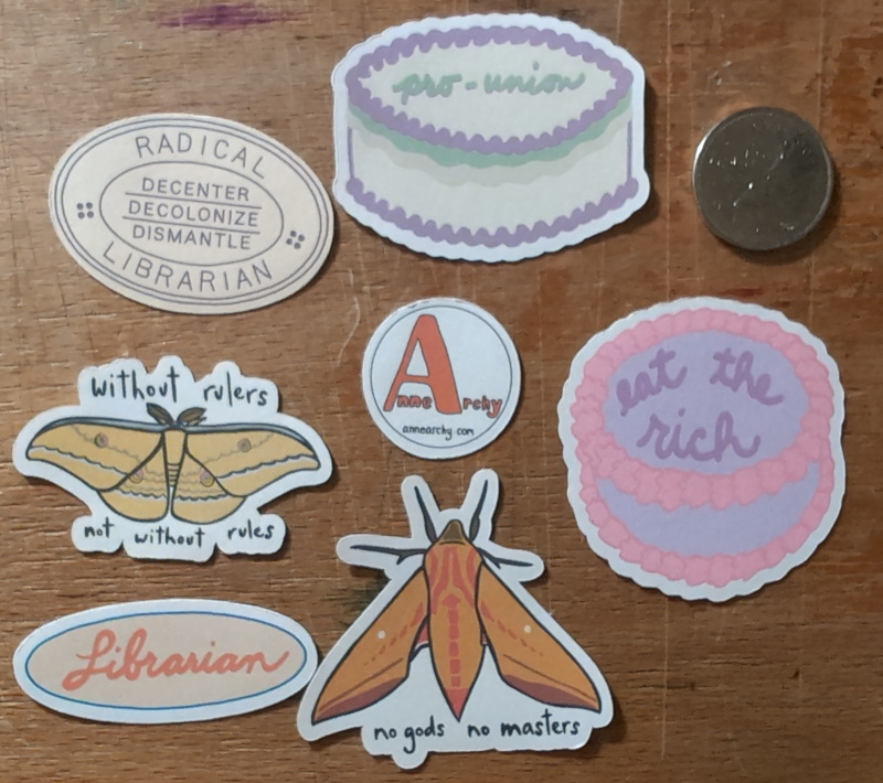 Various stickers (with a Canadian quarter for scale)