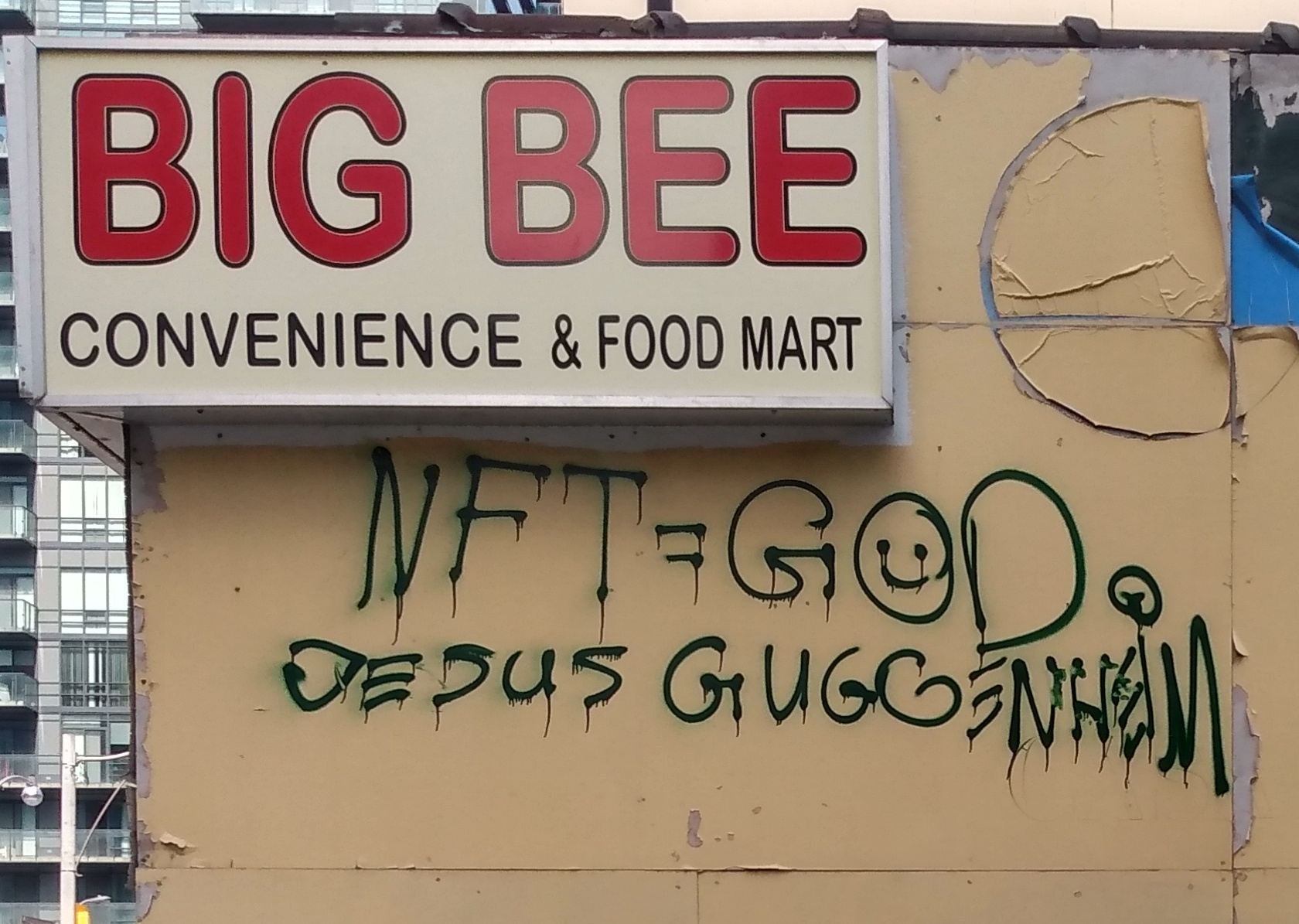 Graffiti saying NFT = G☺d / Jesus Guggenheim